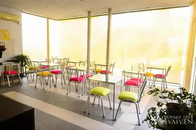 a room with tables and chairs and a large window at Del Vaiven in Villa Carlos Paz