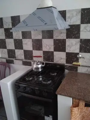 a kitchen with a stove with a tea pot on it at Los Horneros in Villa Cura Brochero