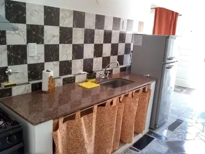 a kitchen with a sink and a refrigerator at Los Horneros in Villa Cura Brochero