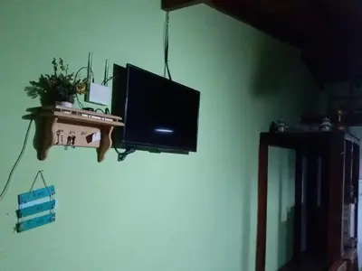 a flat screen tv hanging on a wall at Cabañas Los Abuelos in Santa Rosa de Calamuchita