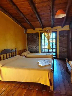 a bedroom with two beds in a room at Cabañas Pinares al Alba in Almafuerte