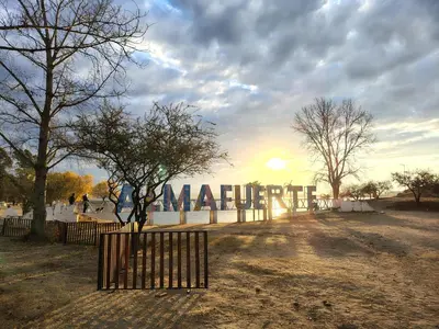 a gate in front of a sign that reads marmite at Cabañas Pinares al Alba in Almafuerte