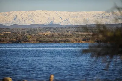 a large body of water with mountains in the background at Cabañas Pinares al Alba in Almafuerte