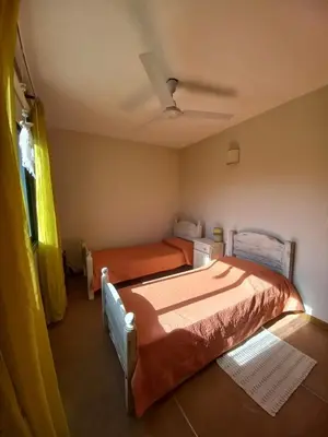 a bedroom with two beds and a ceiling at CuyenCo in Santa Rosa de Calamuchita
