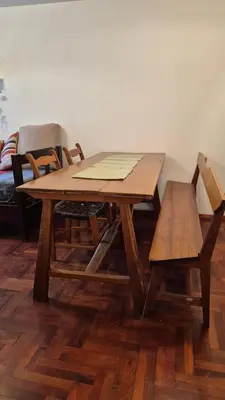 a wooden table with two chairs and a table and bench at Espacio C Obispo Salguero in Cordoba