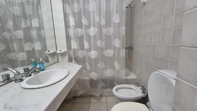 a bathroom with a sink and a toilet and a shower curtain at Espacio C Obispo Salguero in Cordoba