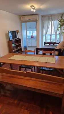 a large wooden table in a living room at Espacio C Obispo Salguero in Cordoba