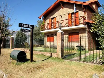 a house with a street sign in front of it at Complejo Steffen in Merlo