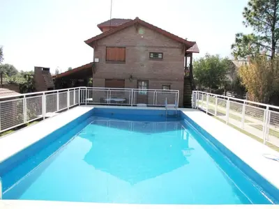 a large swimming pool on the roof of a house at Complejo Steffen in Merlo