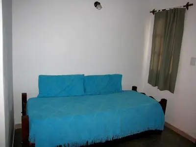 a bedroom with a blue bed with a window at Complejo Steffen in Merlo