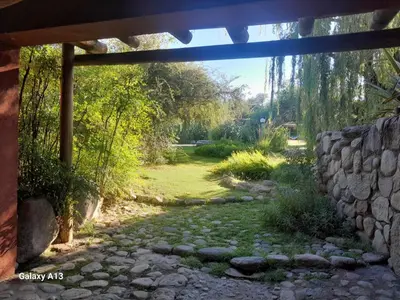 a stone wall and a stone path in a yard at Posada La Valentina in Villa de Las Rosas