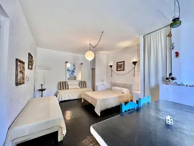 a bedroom with two beds and two chairs in it at La Confianza in Las Chacras (La Paz)
