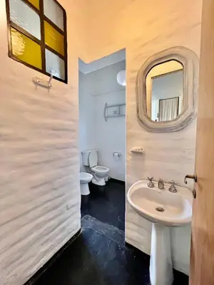 a bathroom with a sink and a toilet and a mirror at La Confianza in Las Chacras (La Paz)