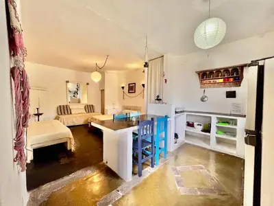 a kitchen and living room with a table and a couch at La Confianza in Las Chacras (La Paz)