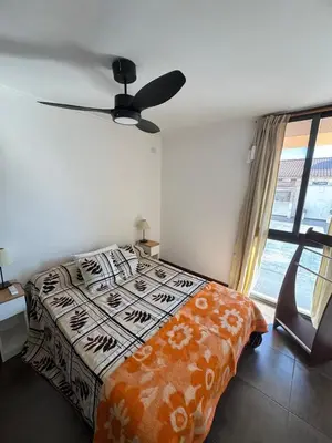 a bedroom with a bed and a ceiling fan at Carlos Paz Roque Sainz Peña in Villa Carlos Paz