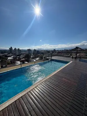 a swimming pool on the roof of a building at Carlos Paz Roque Sainz Peña in Villa Carlos Paz