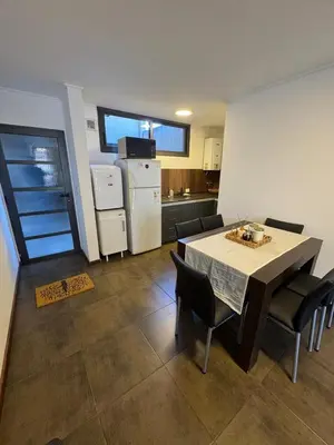 a kitchen and dining room with a table and chairs at Carlos Paz Roque Sainz Peña in Villa Carlos Paz