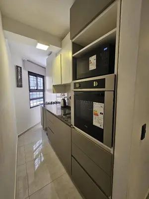 a kitchen with a stove and a microwave at Chic in Cordoba