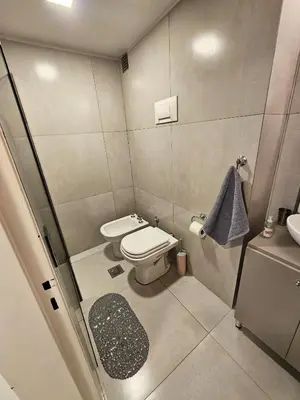 a small bathroom with a toilet and a sink at Chic in Cordoba
