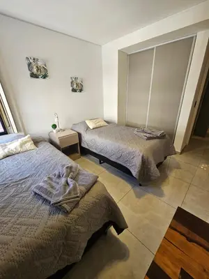 a bedroom with two beds and a window at Chic in Cordoba
