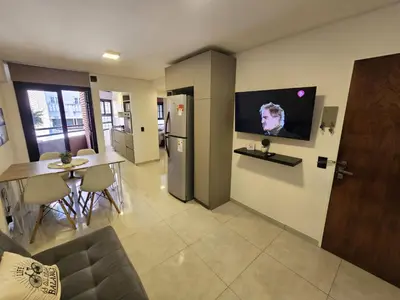 a living room with a television on the wall at Chic in Cordoba