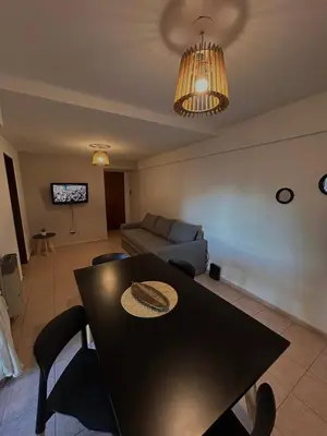 a living room with a table and a couch at Tu estadía ideal, en el corazón de la ciudad in Cordoba