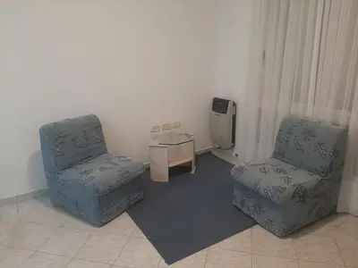a living room with two chairs and a tv at 1º A y 2º A in Cordoba