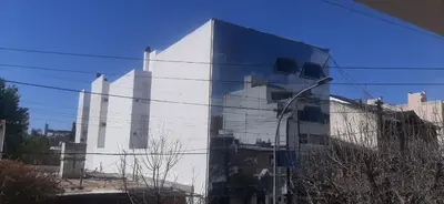 a building reflection in the side of a building at 1º A y 2º A in Cordoba