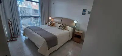 a bedroom with a bed and a large window at 1º A y 2º A in Cordoba
