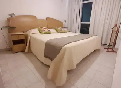 a bedroom with a large bed and a window at 1º A y 2º A in Cordoba
