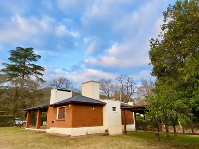 a brick house with a chimney on top of it at Cabañas Montecarlo 1 in Santa Rosa de Calamuchita