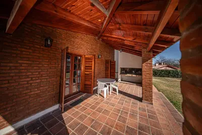 an outdoor patio with a table and chairs at Cabañas Montecarlo 1 in Santa Rosa de Calamuchita