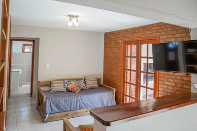 a bedroom with a bed and a television in a room at Cabañas Montecarlo 1 in Santa Rosa de Calamuchita