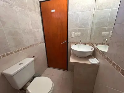 a bathroom with a toilet and a sink at Lo De ADRI in Villa Carlos Paz