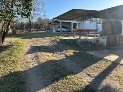 a house with a picnic table in the yard at Lo De ADRI in Villa Carlos Paz