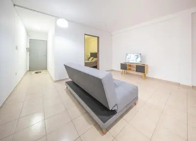 a living room with a gray couch and a table at Hermoso Departamento Planta Baja in Cordoba