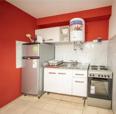a kitchen with a refrigerator and a sink at Hermoso Departamento Planta Baja in Cordoba