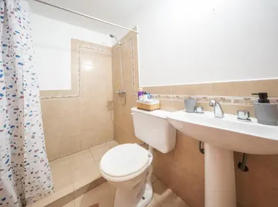 a bathroom with a toilet and a sink at Hermoso Departamento Planta Baja in Cordoba