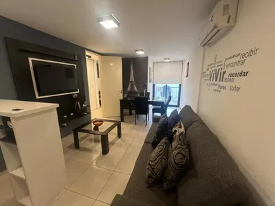 a living room with a couch and a television at Encantador departamento en General Paz in Cordoba