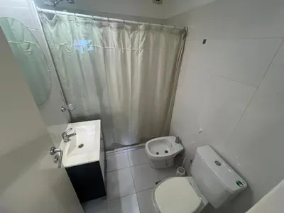 a bathroom with a toilet and a sink and a shower at Encantador departamento en General Paz in Cordoba