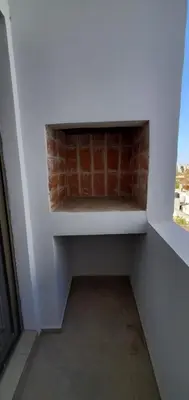 a room with a brick wall next to a window at Encantador departamento en General Paz in Cordoba