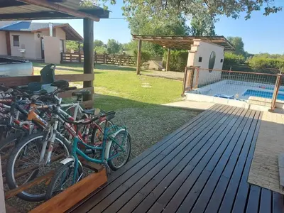a group of bikes parked on a deck next to a swimming pool at Cabañas Finca del molino in Panaholma