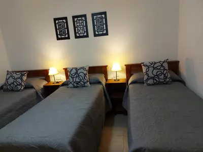 two beds in a room with two lamps at Cabañas Finca del molino in Panaholma