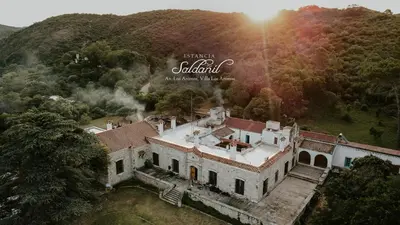 an aerial view of a house in a mountain at Estancia Saldañil in Villa Los Aromos