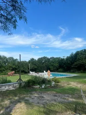 a person standing next to a swimming pool at Estancia Saldañil in Villa Los Aromos