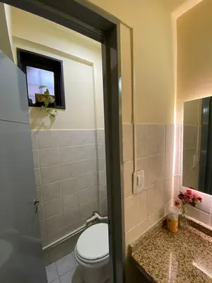 a bathroom with a toilet and a sink and a mirror at Hostel Nueva cordoba Subte Uno in Cordoba