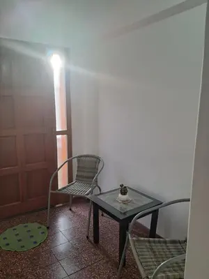 a room with a table and chairs and a door at La Casa de María Helenra in Alta Gracia