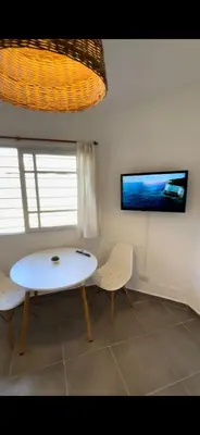 a white table and two chairs in a room at Duplex 1 Dormitorio Costa Azul in Villa Carlos Paz
