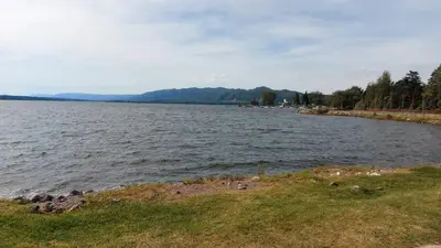 a large body of water with mountains in the background at Castillo Del Lago - Carlos Paz - D19 in Villa Carlos Paz