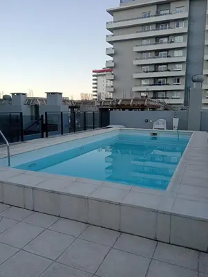 a swimming pool on the roof of a building at Depto Centrico Etoile 4 in Villa Carlos Paz